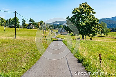 Summer mountain landscape with blue sky, Road through a meadow - Moravian-Silesian Beskydy, Grun, Czechia Stock Photo