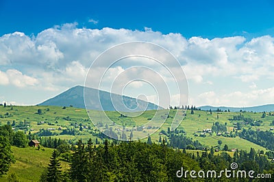 Summer mountainous rural landscape view with a old house and spruce Carpathian Ukraine Stock Photo