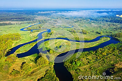 Summer nature landscape from above. River aerial view. Green meadow on riverside in the morning. Spring background Stock Photo