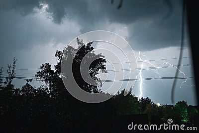 Summer night thunderstorm with powerful lightning in the village Stock Photo