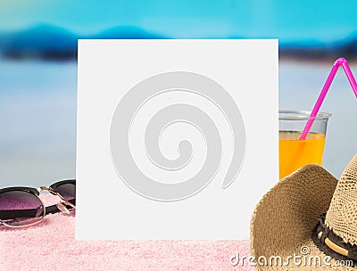 Summer offer background template for promotion and sales. Sunglasses, cocktail and brimmed hat on towel with beautiful paradise. Stock Photo