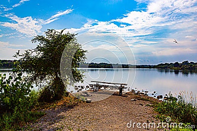 Summer in Omaha, Panorama Shoreline and sky reflections in the lake at Ed Zorinsky Lake Park Omaha NE Stock Photo