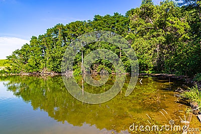 Summer in Omaha, Reflection of shoreline forest on the lake Ed Zorinsky lake park, Omaha, Nebraska, USA Stock Photo