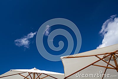 Summer Parasols Under A Blue Sky Stock Photo