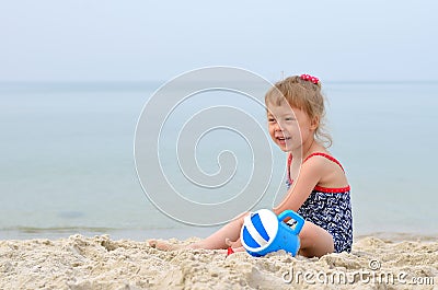 Summer Photo - charming girl playing on a sandy beach, space for Stock Photo