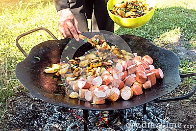 Summer picnic. Preparation of delicious sausages Stock Photo