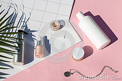 Summer pink cosmetics on the noon sun flat lay . Sunscreen concept. Top view beauty composition. Stock Photo