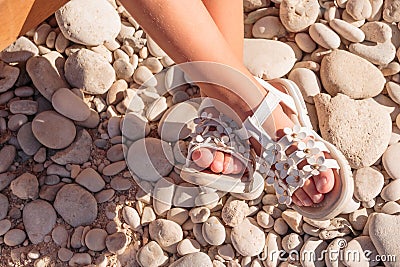 Summer white Shoes for kids, Children`s slippers, beach fashion for baby, Colorful of Sandals shoes and stones, holiday Stock Photo