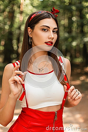 Summer portrait beautiful pretty young woman with red lipstick and sexy lips in white youth top in red fashionable sundress in Stock Photo