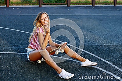 Summer portrit of stylish girl with skateboard Stock Photo