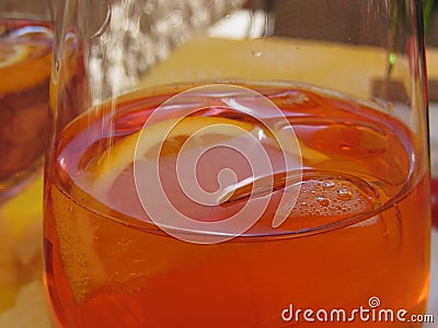 Summer refreshing aperitif drink on the rocks . Spritz cocktail with lemon slice Stock Photo