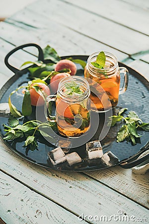 Summer refreshing cold peach ice tea on tray, copy space Stock Photo