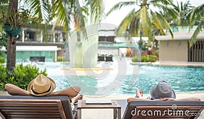 Summer resort hotel stay relaxation with tourist traveller couple take it easy happily resting on beach chair on holiday travel Stock Photo