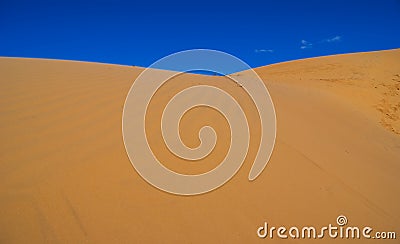 Summer sandy desert dune on a blue sky backgrou Stock Photo