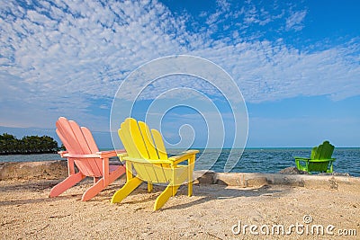 Summer scene with colorful lounge chairs on a tropical beach Stock Photo