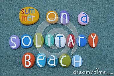 Summer on a solitary beach, vacation dream slogan composed with multi colored stone letters on sand Stock Photo