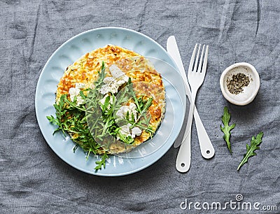 Summer squash frittata with goat cheese and arugula - delicious healthy diet food, breakfast, snack on a gray background Stock Photo