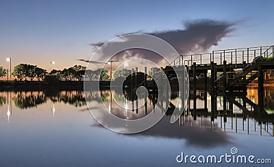 Summer sunset on the lake with clouds reflection Stock Photo