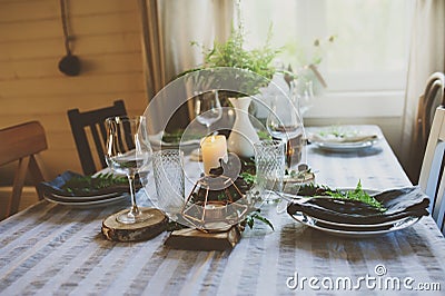 Summer table setting in natural organic style with handmade details in green and brown tones Stock Photo