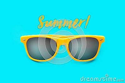 Summer! text and yellow sunglasses in intense cyan blue background. Minimal image concept for ready for summer Stock Photo