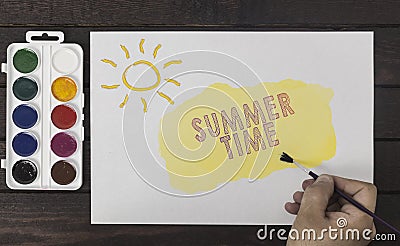 Summer time concept. Artist`s hand with a brush painting. Stock Photo
