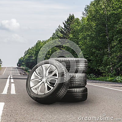summer tires and alloy wheels set on an asphalt road. tire change season, auto trade, copy space, square photo Stock Photo