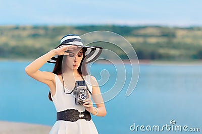 Summer Tourist Girl with Retro Camera and Big Straw Hat Stock Photo