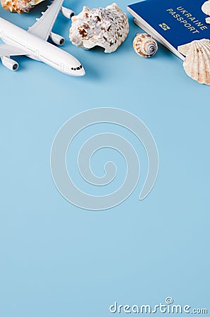 Summer travel concept. Decorative airplane, passports, hat and seashells Stock Photo