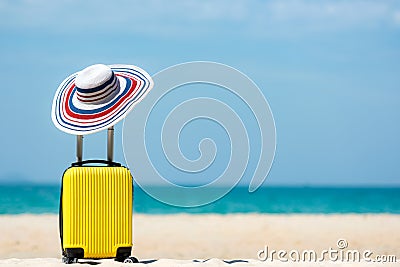 Summer travel and plan with yellow suitcase luggage in the sand beach. Travel in the holiday trips, airplane and blue sky backgrou Stock Photo