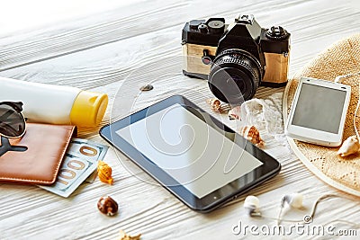 summer travel vacation concept, space for text. empty tablet screen, camera sunglasses passport money phone hat shells on white w Stock Photo