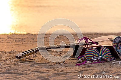 Summer traveling with guitar and Fashion woman swimsuit Bikini, fish star, sun glasses, hat on the sand beach in the holiday, Stock Photo