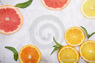 Summer tropical juice concept with lemon, grapefruit and orange on luxury marble kitchen table. Flat lay. Fresh smoothie beverage Stock Photo