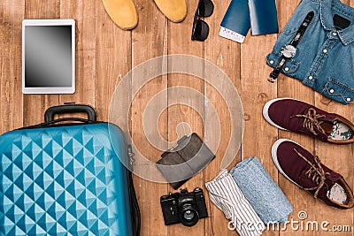 Summer vacation background with travel accessories. closed luggage, shoes, digital devices and passports Stock Photo