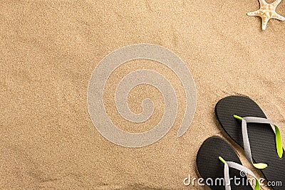 Summer vacation composition. Flip flops and seashell on sand background Stock Photo