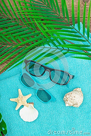 Summer vacation concept. Bath towel, sunglasses, marine decor Stock Photo