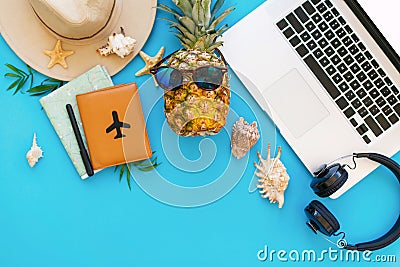 Summer vacation concept, flat lay. laptop, pineapple in sunglass Stock Photo