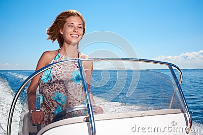 Summer vacation - girl driving a motor boat Stock Photo