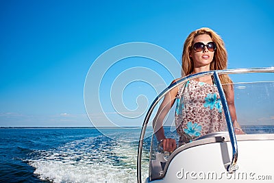 Summer vacation - girl driving a motor boat Stock Photo