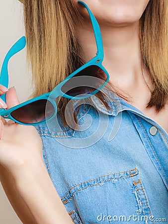 Summer vacation. Sunglasses in female hand Stock Photo