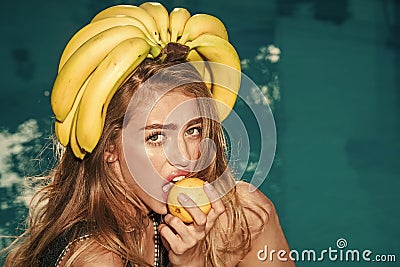 Summer vacation and travel to ocean. woman with tropical fruit in pool. Vitamin in banana at girl near water Stock Photo