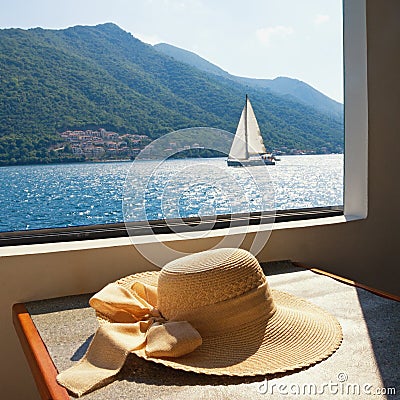 Summer vacation. Women`s sun hat on the table of pleasure ship Stock Photo
