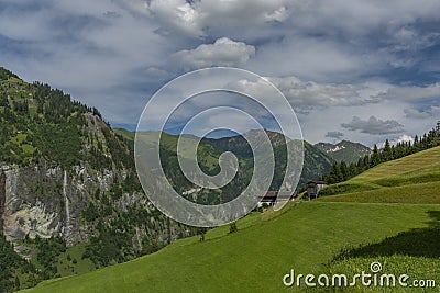 Summer valley with Grossarler Ache small river and blue cloudy sky Stock Photo