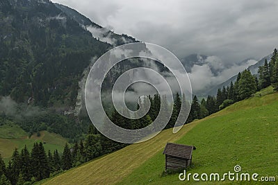 Summer valley with Grossarler Ache small river and blue cloudy sky Stock Photo