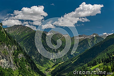 Summer valley with Grossarler Ache small river and blue cloudy sky Stock Photo