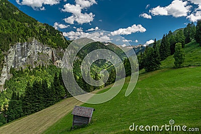 Summer valley with Grossarler Ache small river and blue cloudy sky Stock Photo