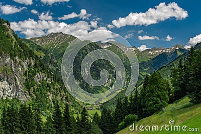 Summer valley with Grossarler Ache small river and blue cloudy sky Stock Photo