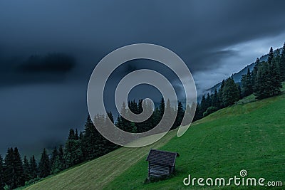 Summer valley morning with fog with Grossarler Ache river and blue cloudy sky Stock Photo