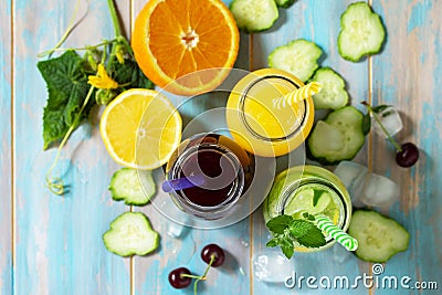 Summer various refreshments drinks. Cherry juice, detox cucumber water and orange juice Stock Photo
