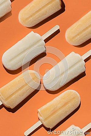 Varying popsicles on an orange background. Flat lay of ice creams in pop-art style Stock Photo