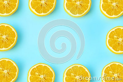 Summer and vitamins background frame. Lemon on a blue background, minimal food concept Stock Photo